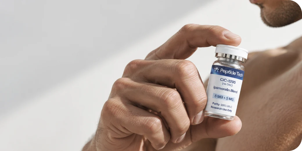 A hand holding a PeptideTech research vial