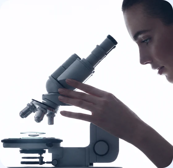 A scientist examining a sample under a microscope